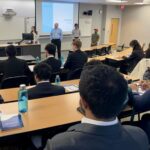 Photo of Arch Mortgage representatives giving a presentation to FM students.