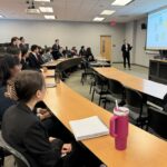 Photo of Charles Schwab representative giving a presentation to FM students.