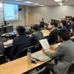 Photo of Financial Risk Group representatives giving a presentation to FM students.