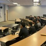 Photo of NC Department of Treasury representative giving a presentation to FM students.