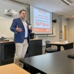 Photo of S&P Global representative giving a presentation to FM students.