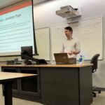 Photo of State Employee's Credit Union representative giving a presentation to FM students.
