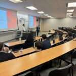 Photo of Vanguard representatives giving a presentation to FM students.